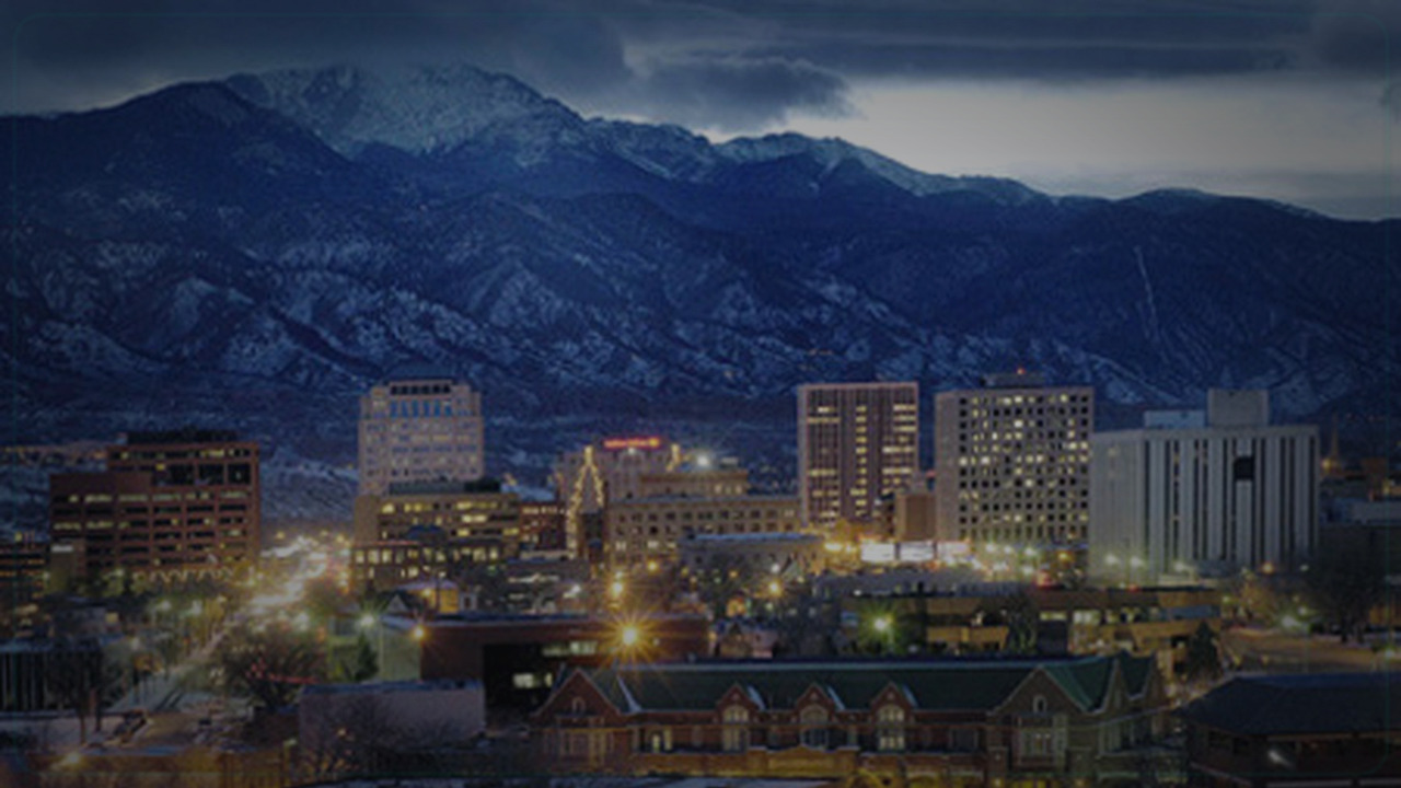 Colorado Springs skyline themed Pine Script service cover with dark market grading