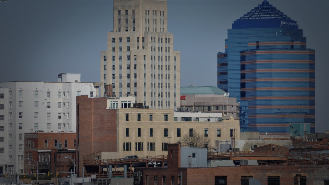 Durham skyline themed Pine Script service cover with dark market grading